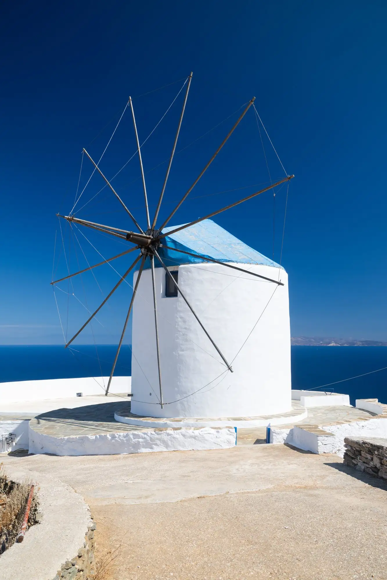 Le moulin, son toit bleu et les rayons de ses ailes